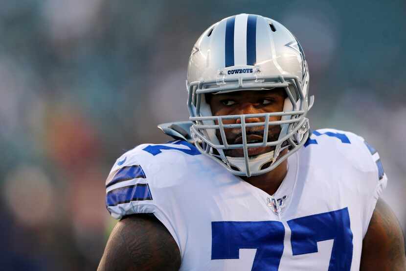 FILE- Cowboys offensive tackle Tyron Smith (77) warms up before a game against the Eagles at...