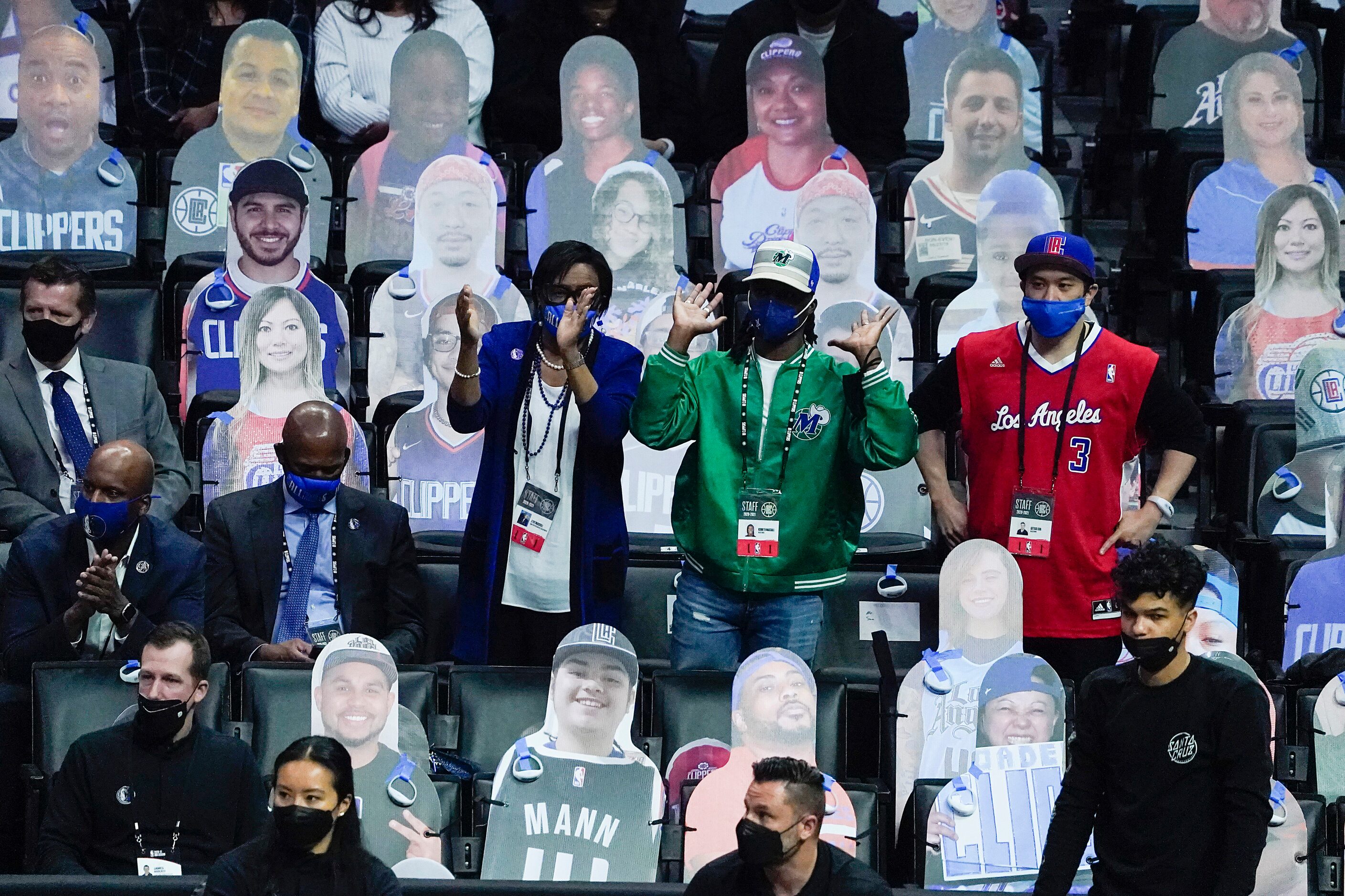 Dallas Mavericks chief executive officer Cynt Marshall (center) cheers a Mavericks basket...