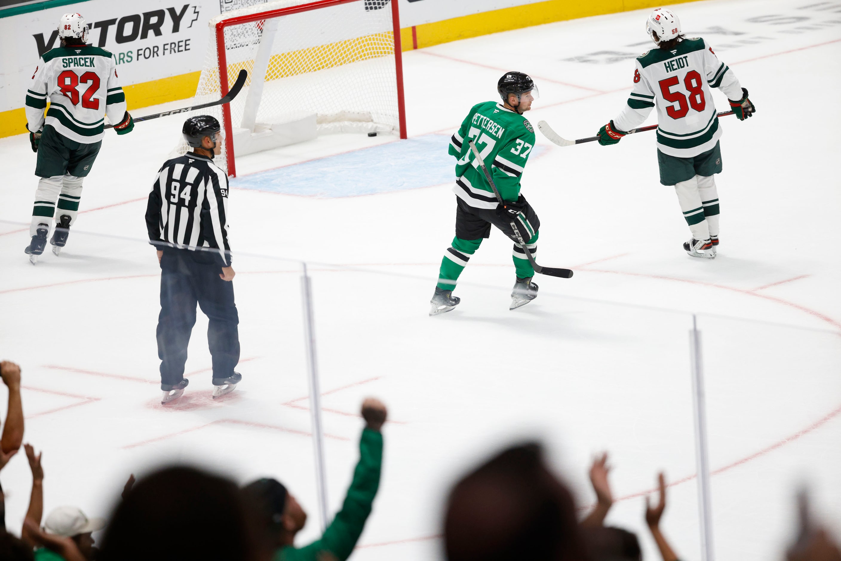 Fans cheer as Dallas Stars center Emilio Pettersen (37) scores a goal against Minnesota Wild...