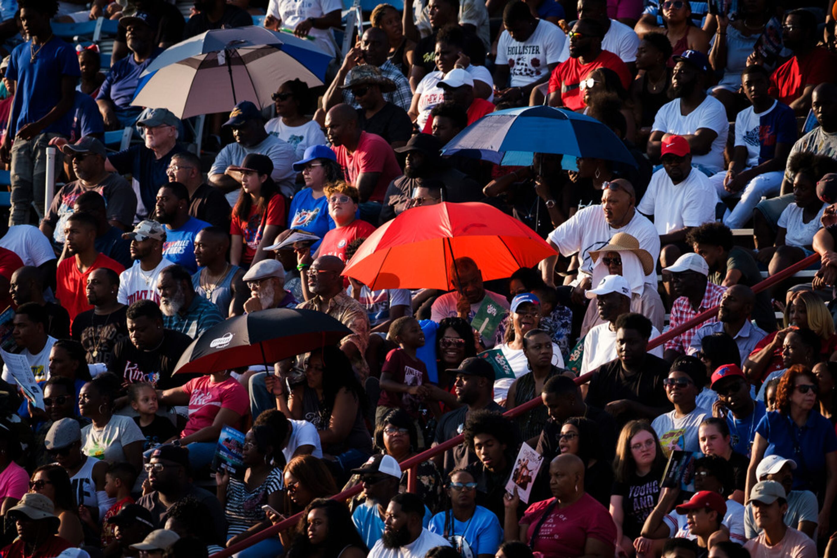 Duncanville fans try to find shade in the stands during the first half of a high school...