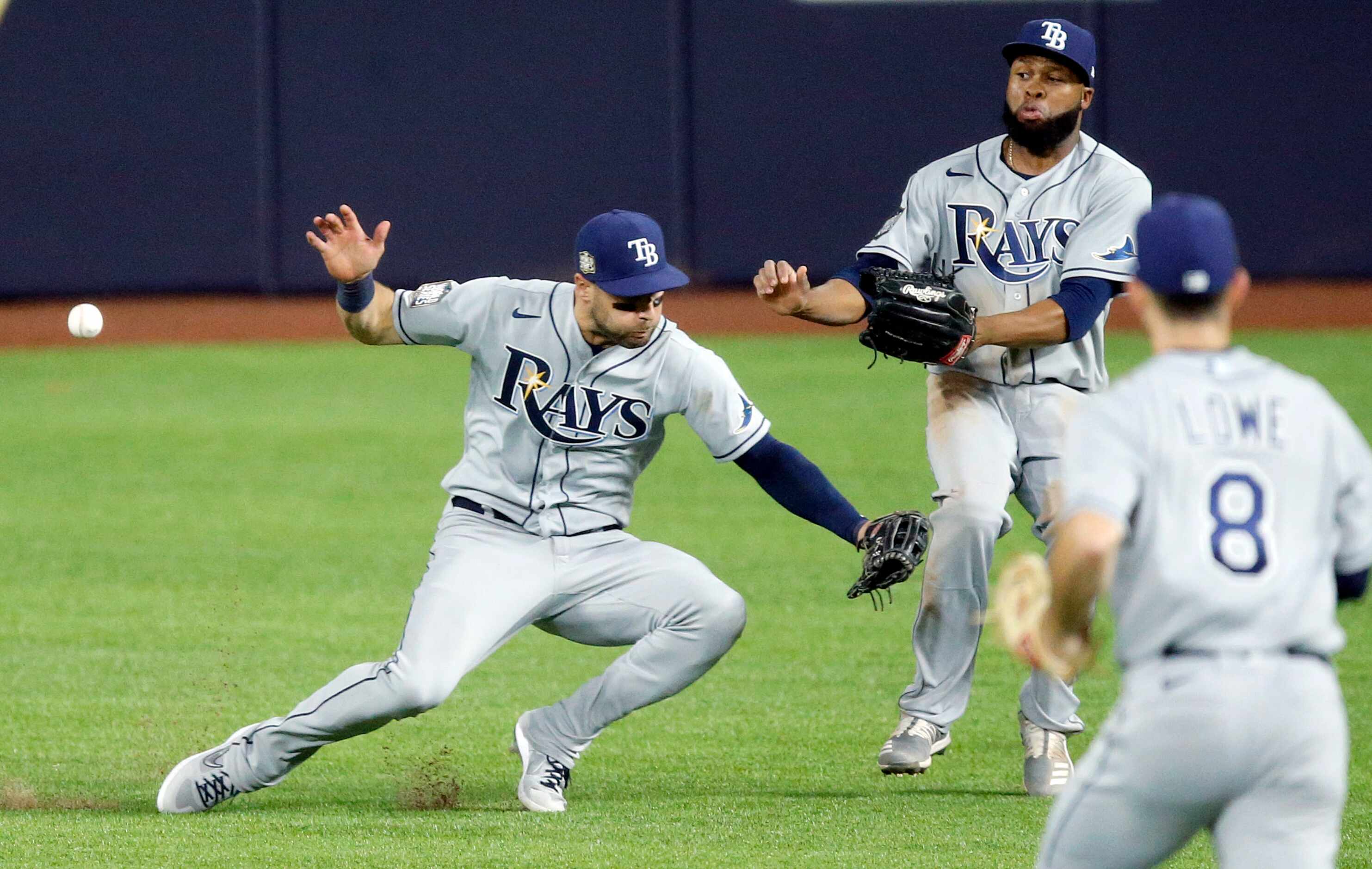Tampa Bay Rays center fielder Kevin Kiermaier (left) almost collides with right fielder...