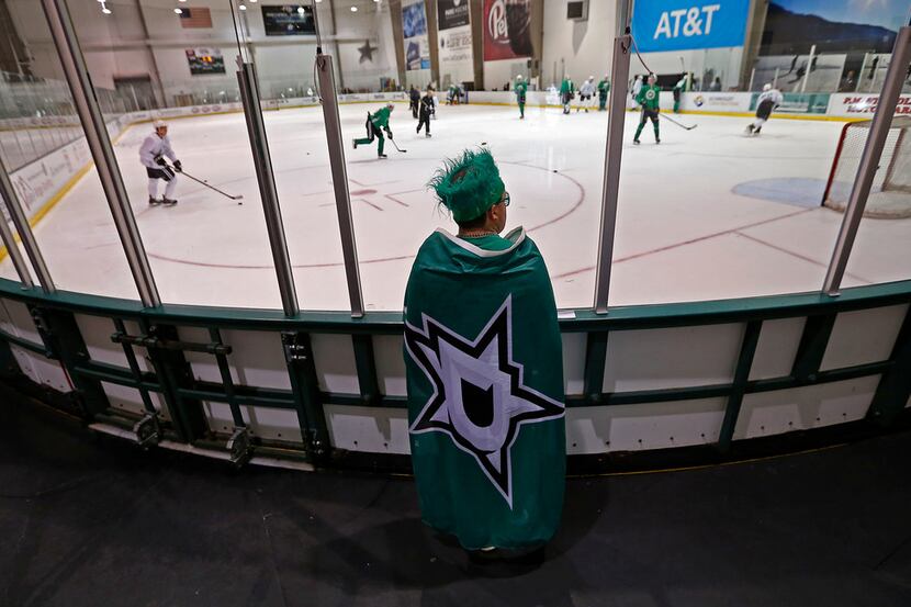 Dallas Stars fan Evan Richard watches as Stars players practice during Development Camp at...