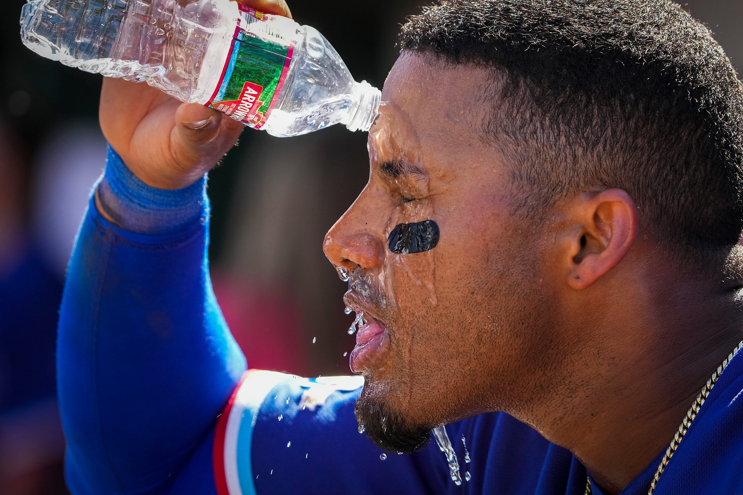 Texas Rangers infielder Andy Ibáñez cools off in the dugout during the third inning of a...