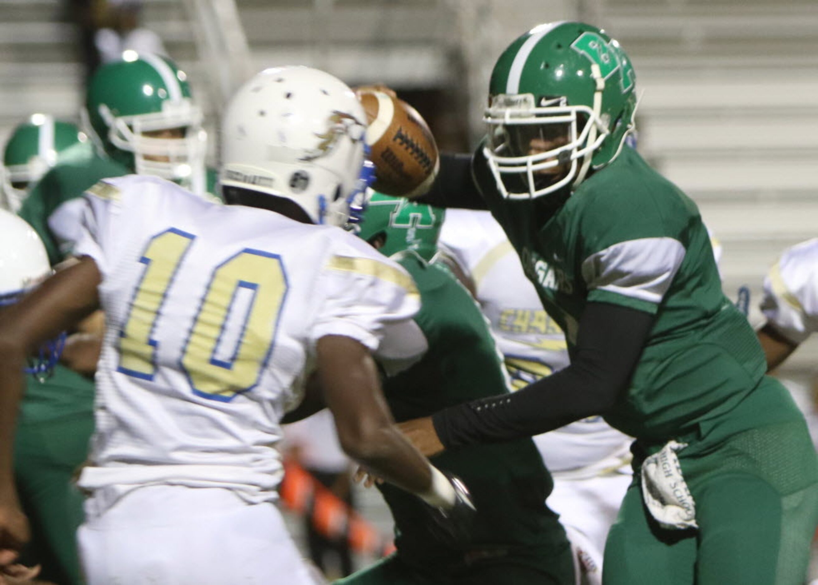 Bryan Adams quarterback XaiyViyon Mccain (2) eyes the defense of Conrad's Martin Harding...