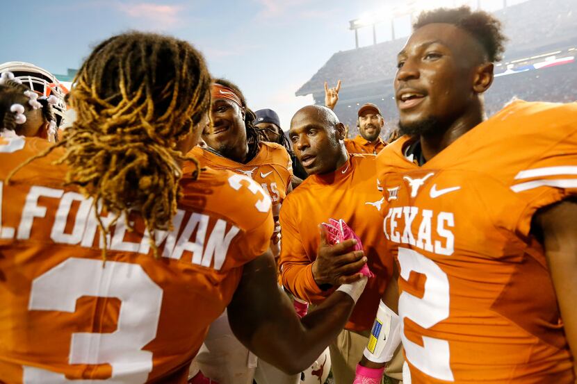 Texas head coach Charlie Strong (second from right) celebrates a 35-34 win over Baylor with...