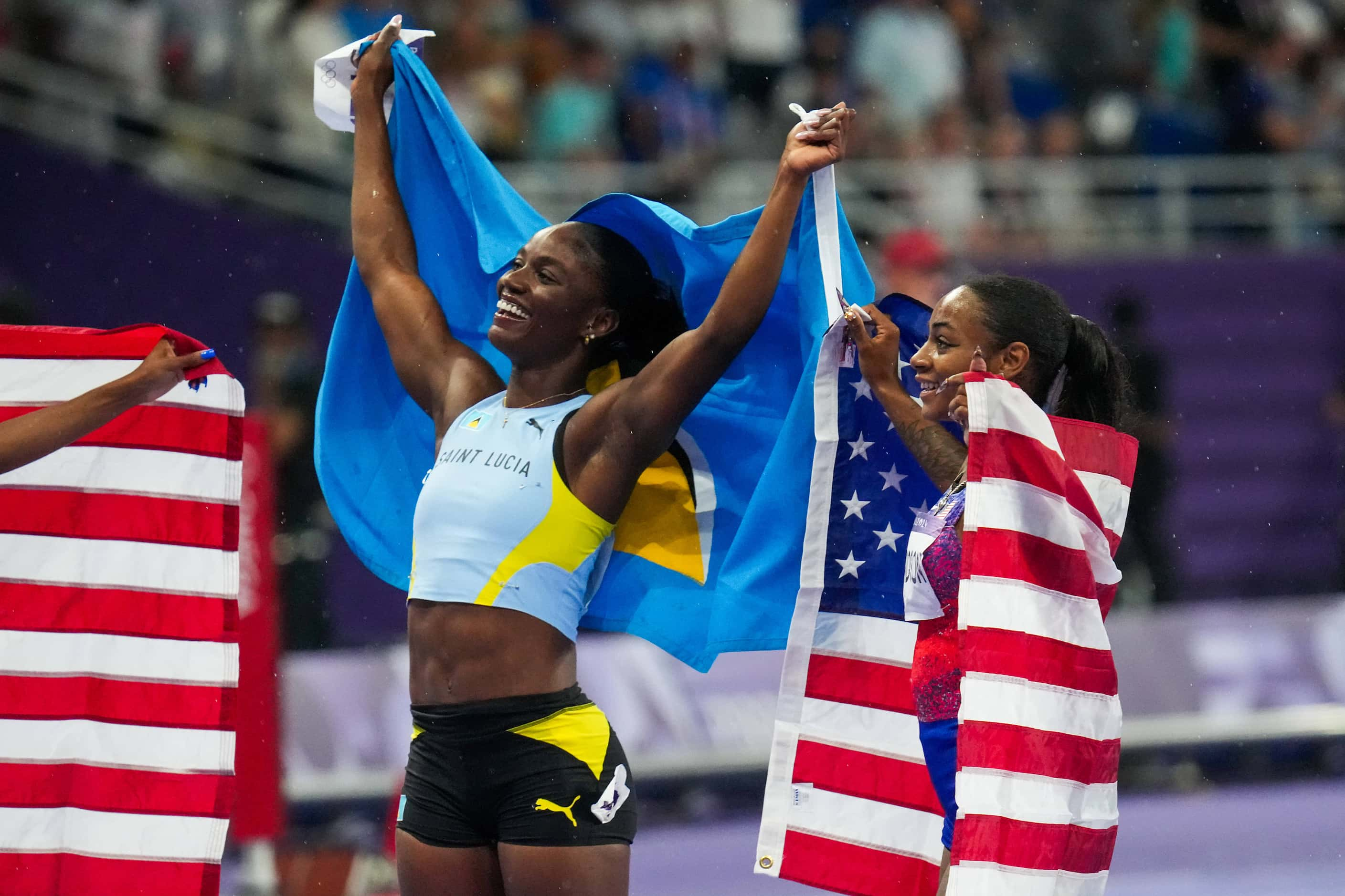 Gold medalist Julien Alfred of Saint Lucia celebrates with silver medalist Sha'carri...