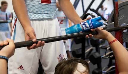 Borden County High School senior Tommy Kingston holds a Lysol bottle while spotting during a...