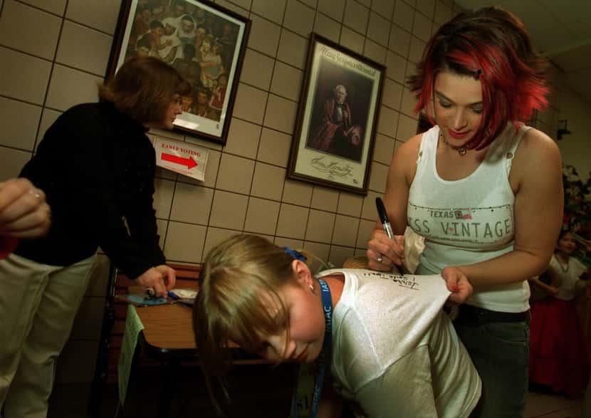Nikki McKibbin autographs eight-year-old Terra Ternes' shirt in Grand Prairie in 2003.