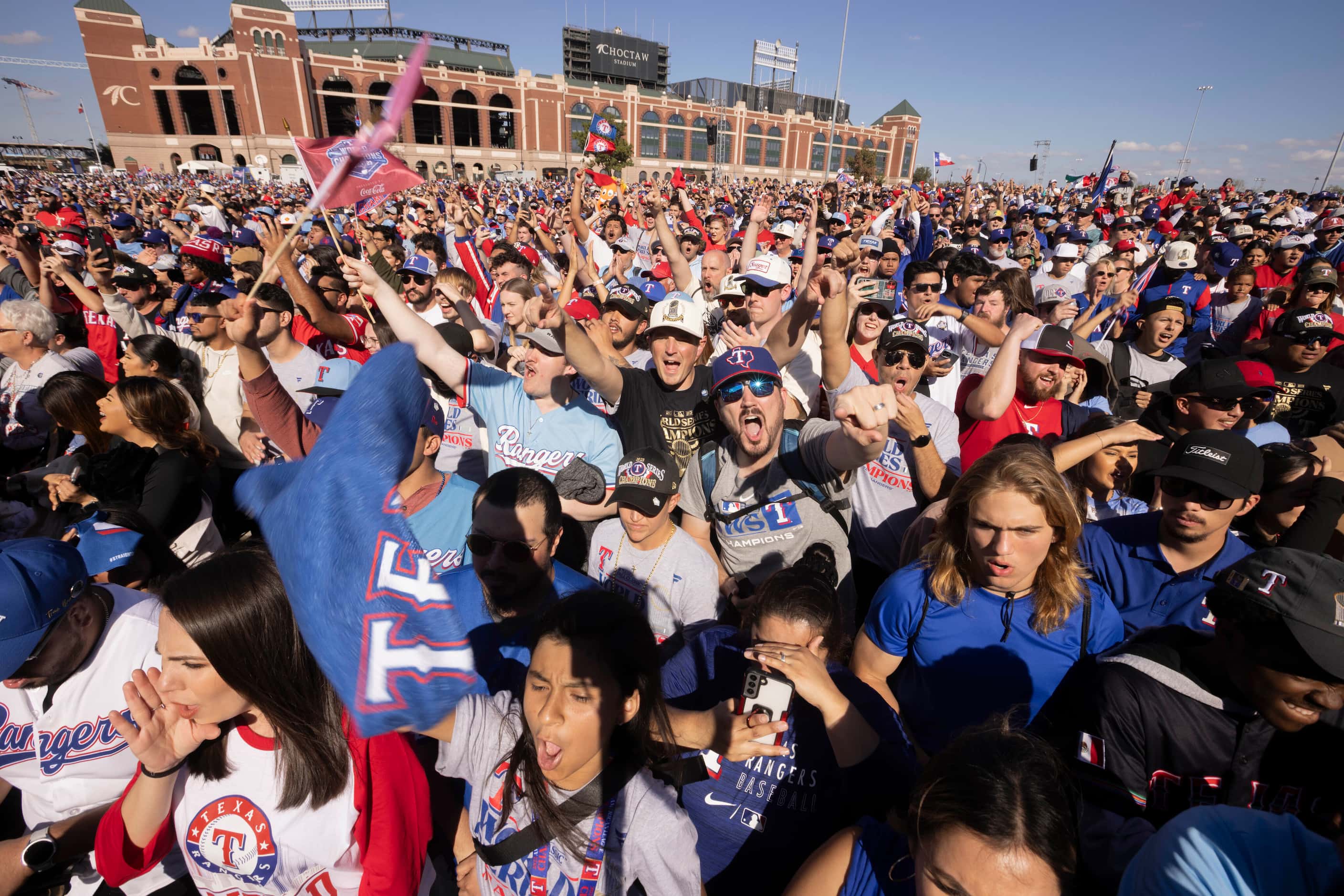 Texas Rangers fans cheer at Globe Life Field’s Lot B in Arlington as the team takes the...