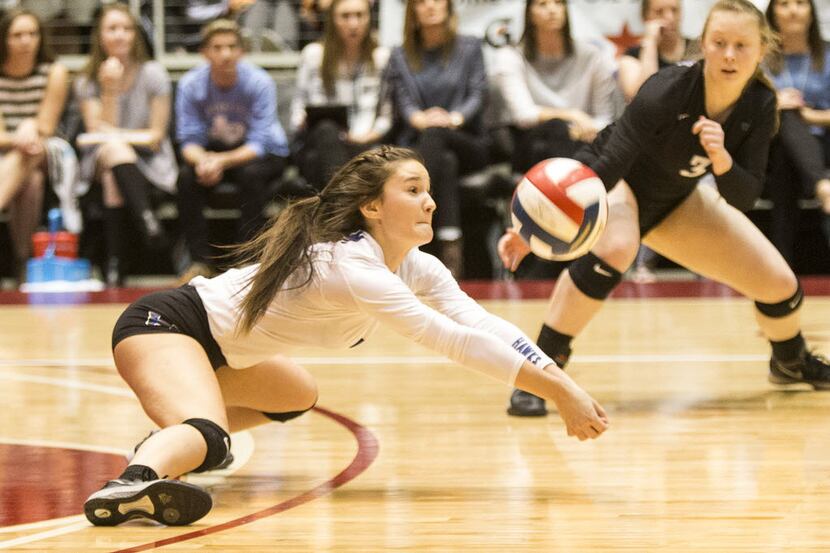 Hebron's Annie Benbow (7) dives for a dig during Lewisville Hebron's 6A state championship...