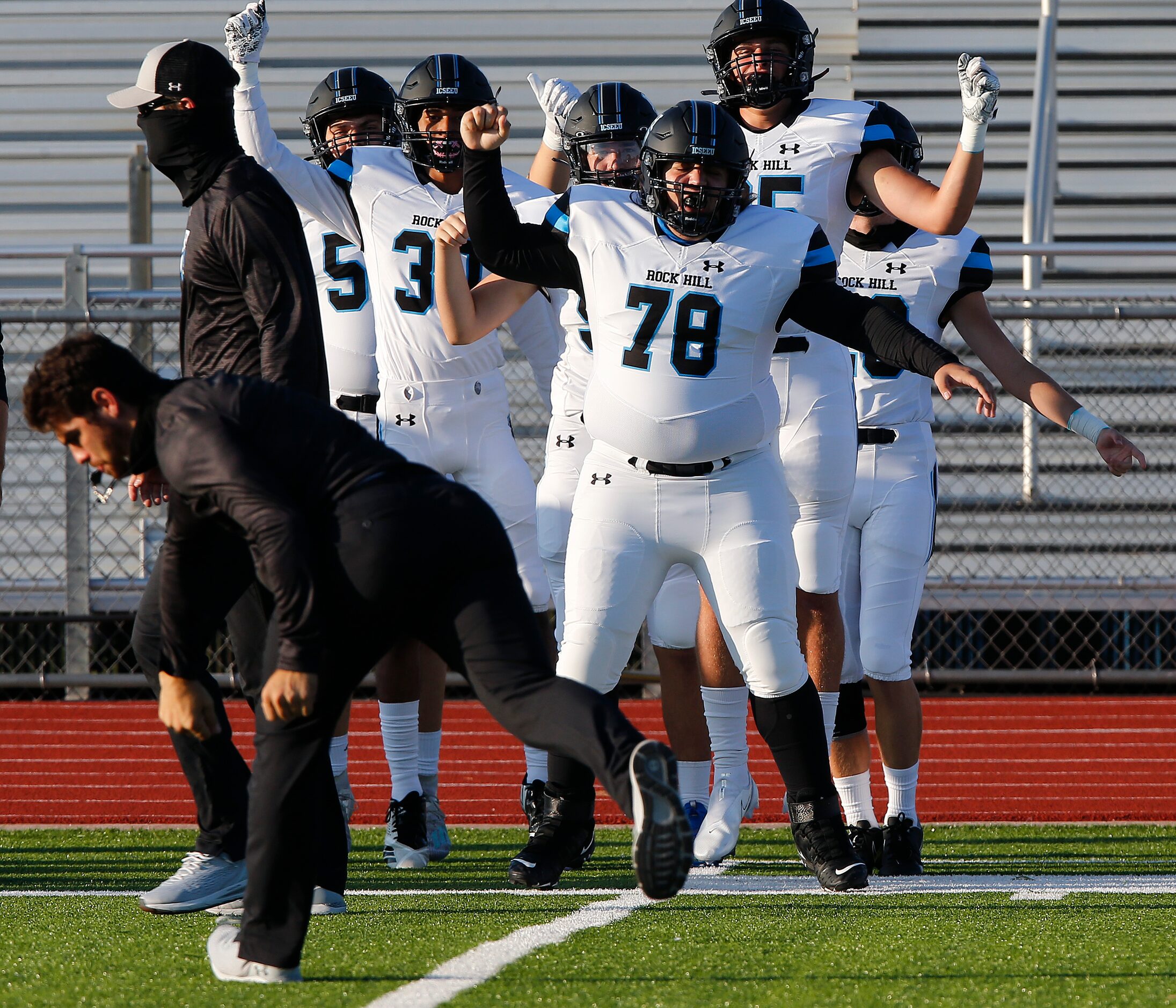 Rock Hill High School players are lead through warm ups by receivers coach Brain Baca...