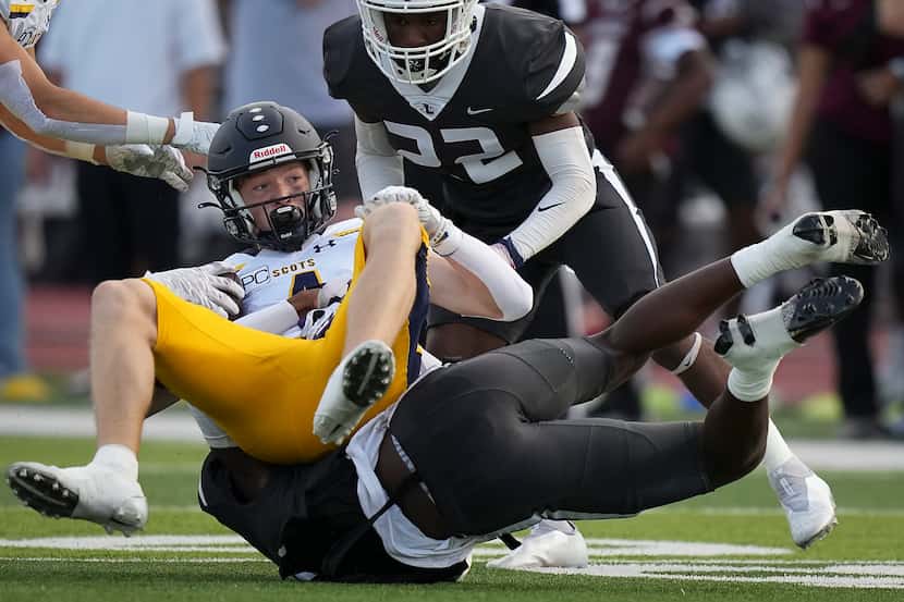 Highland Park’s  Beau Lilly(4) is upended by Lewisville defensive back Cameren Jenkins (2)...