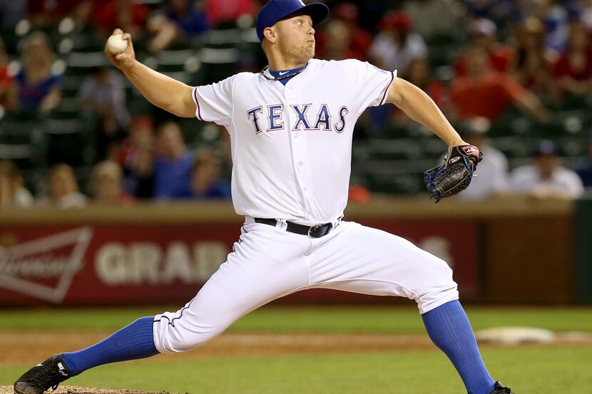 Texas Rangers relief pitcher Seth Rosin (19) throws in the inning of MLB Baseball action...