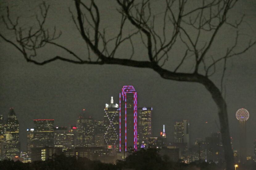 The glow returned to the Bank of America Plaza in Dallas on Thursday as its LED lights were...