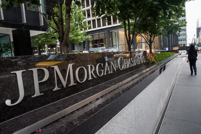FILE - A woman walks past JP Morgan Chase's corporate headquarters on August 12, 2014 in New...