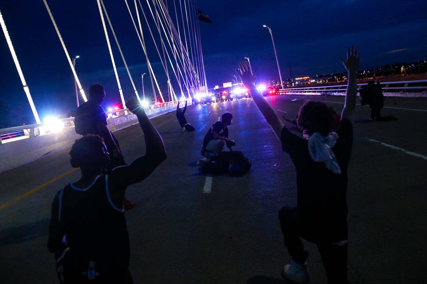 Protesters march onto the Margaret Hunt Hill Bridge as the demonstrate against police...