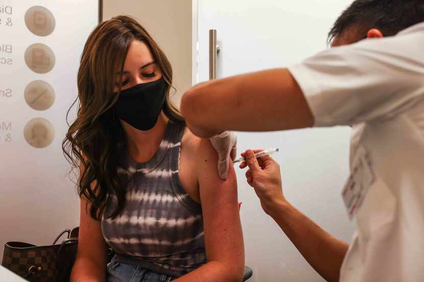 Jennifer Mrusek, 25, gets a a free COVID-19 vaccine at CVS on West Campbell Road to get a...