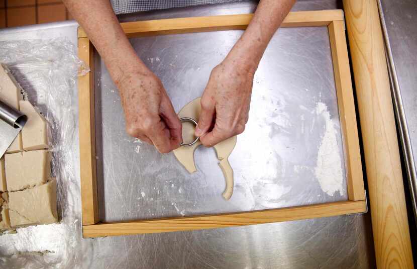 
Assistant baker Susie McMinn cuts out the dough in the kitchen of Westminster Presbyterian...