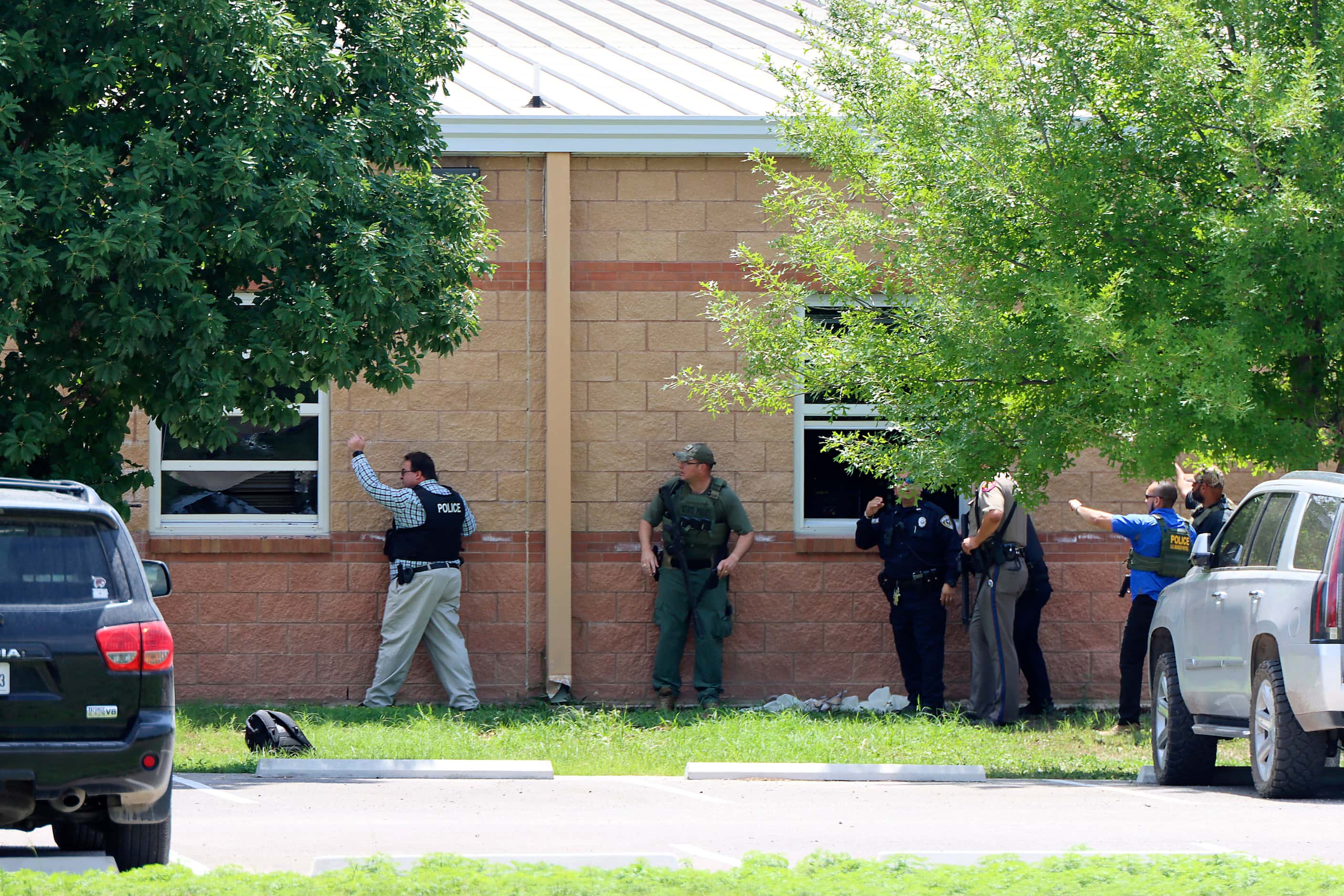 Law enforcement officers are seen outside classroom windows in a photo by Pete Luna, General...