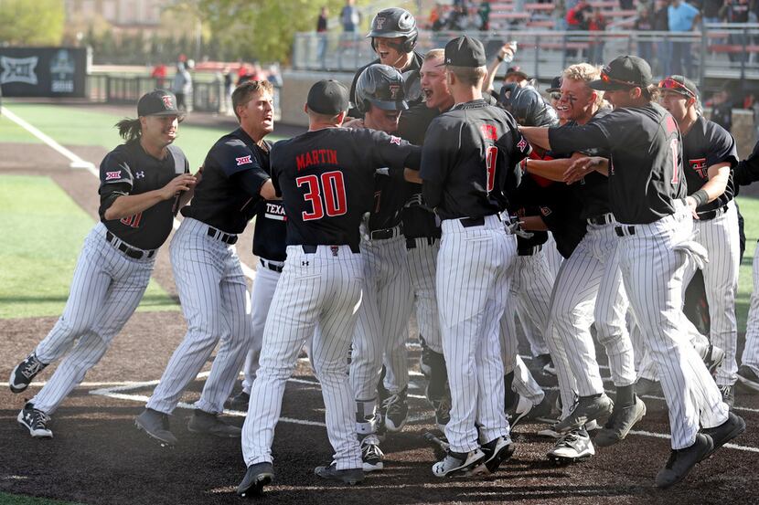 Texas Tech players celebrate after a walkoff balk to win an NCAA college baseball game...
