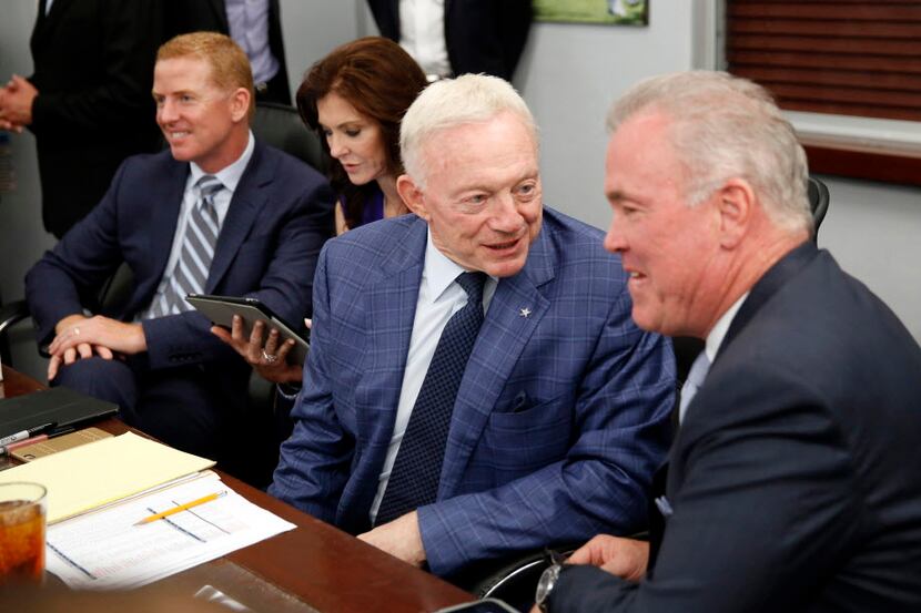 Dallas Cowboys owner Jerry Jones (second from right) visits with his son Stephen Jones...