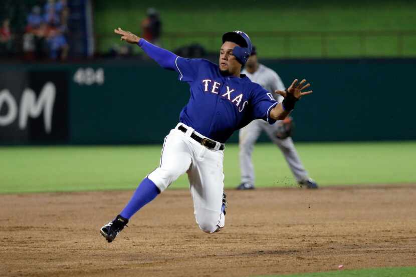 Texas Rangers' Carlos Gomez steals third with Robinson Chirinos at bat in the seventh inning...