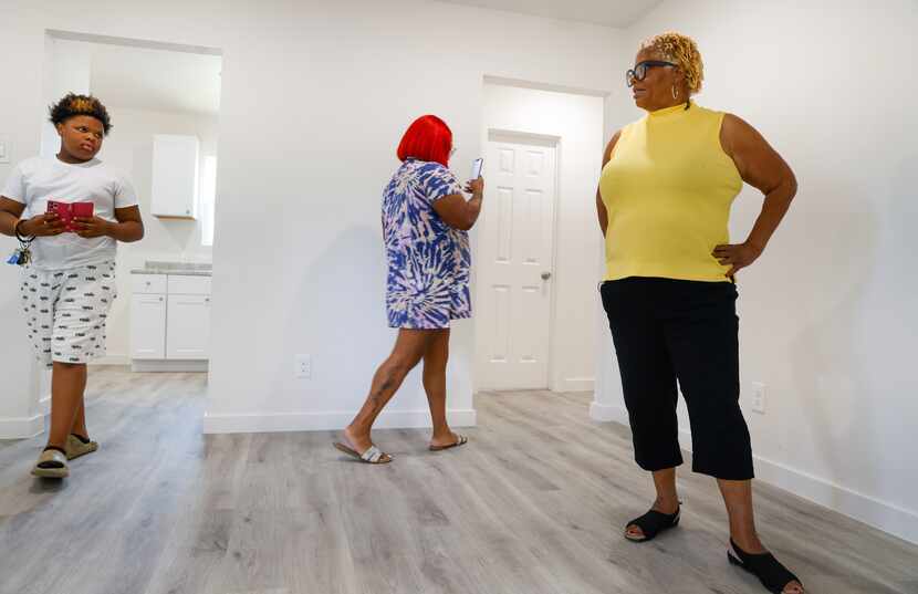 Godson Braylon Turner (left), 11, and daughter Sheniqua Jones (center) record on their...