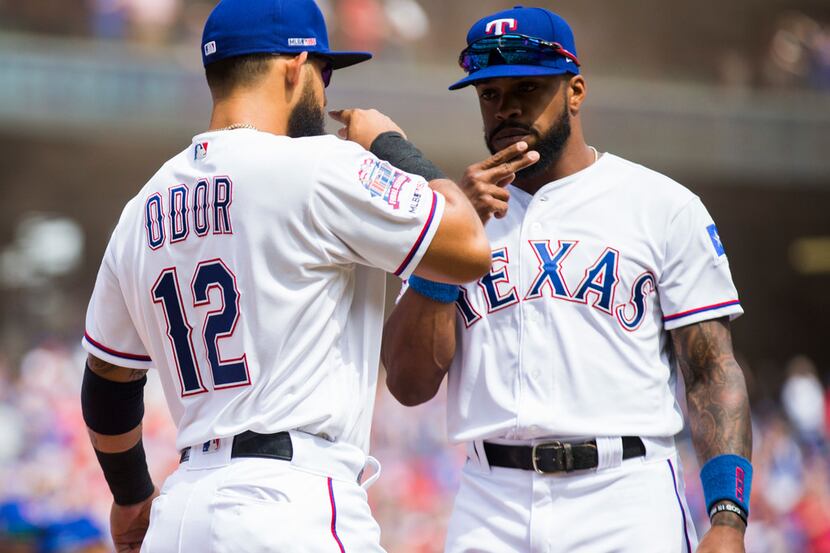 Texas Rangers second baseman Rougned Odor (12) and center fielder Delino DeShields (3) greet...