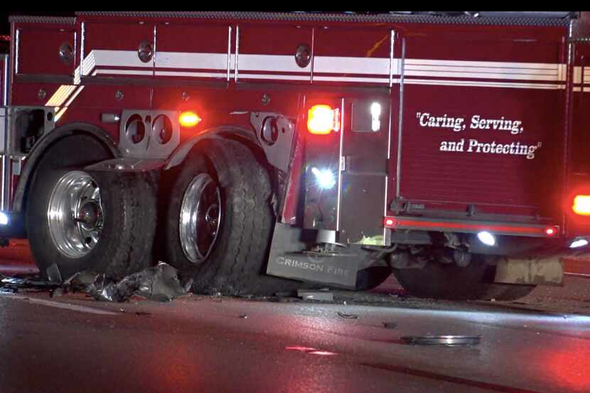 A wrecked fire engine lies in the road after it was struck by an SUV Thursday morning on...