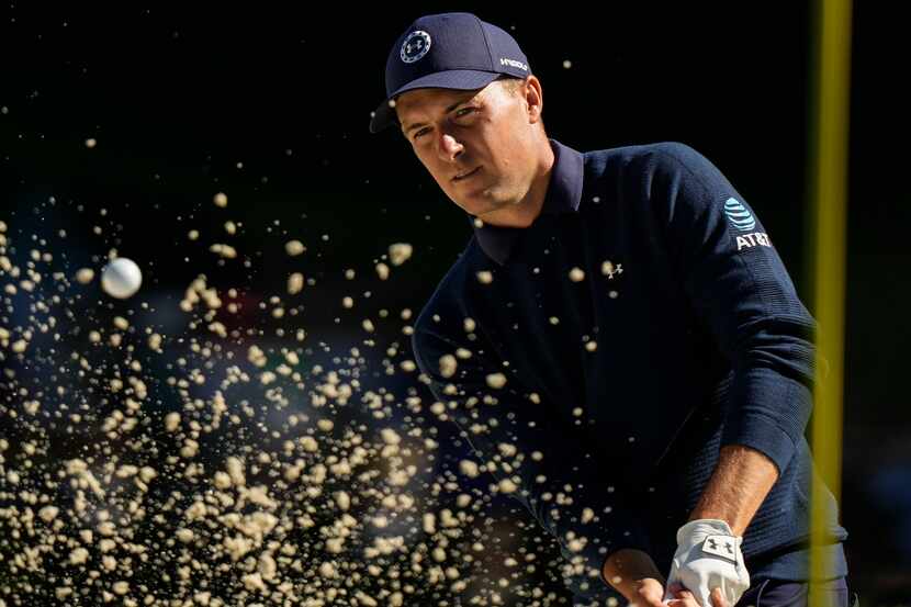 Jordan Spieth hits from the bunker on the 16th hole during the final round of the Masters...