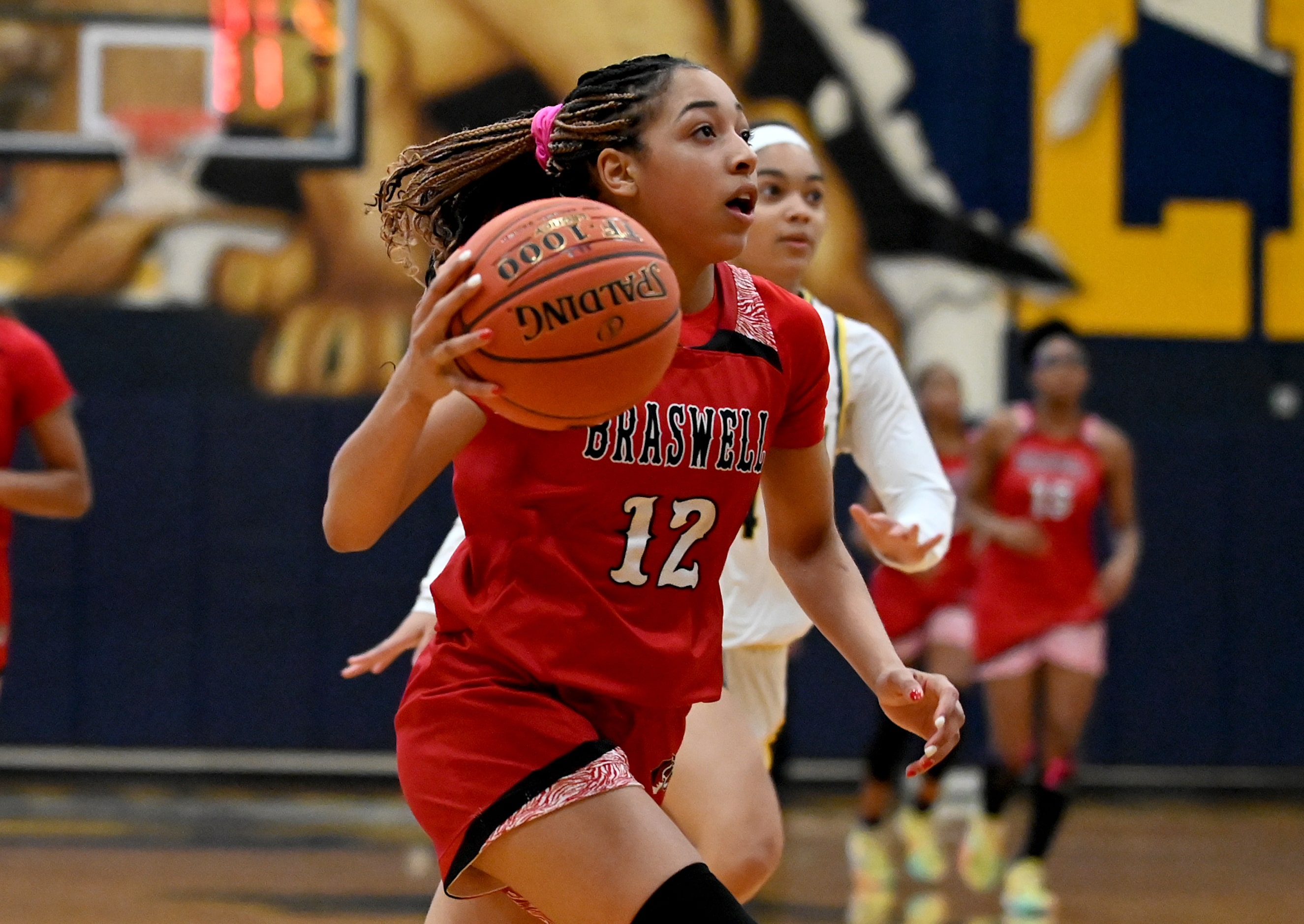 Braswell’s Jazmyne Jackson (12) drives to the basket  in the second half during a girls high...