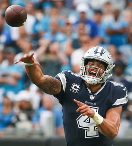Cowboys quarterback Dak Prescott (4) fires off a pass during a game against the Panthers on...