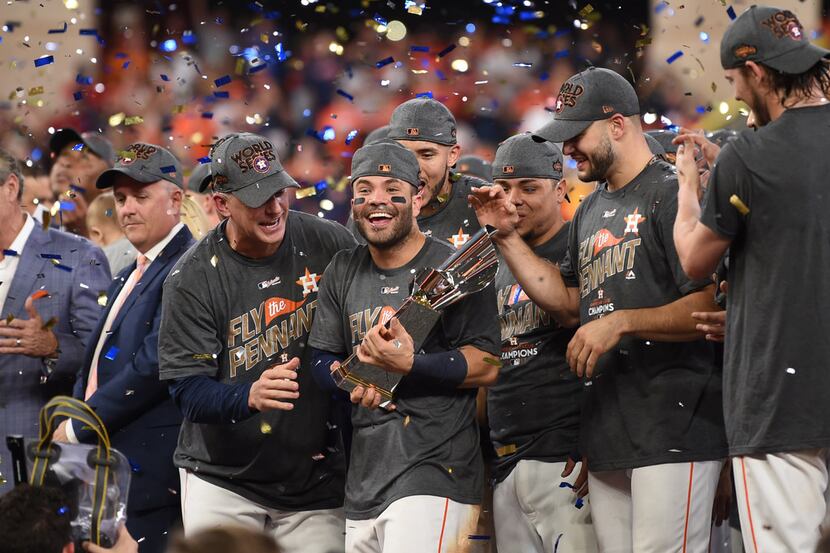 Jose Altuve (center) and the Houston Astros celebrate winning the pennant with a 4-0 win...