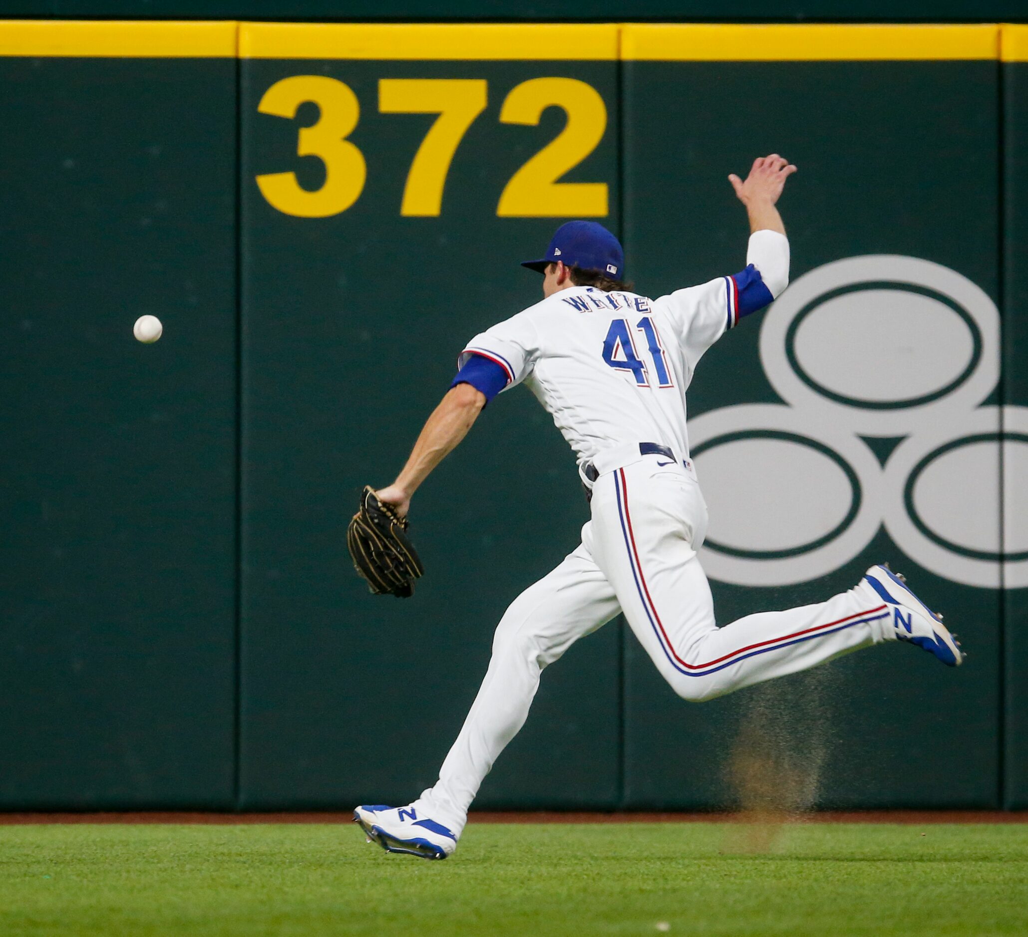 Texas Rangers shortstop Eli White (41) fails to catch Los Angeles Angels Jo Adell’s (7)...