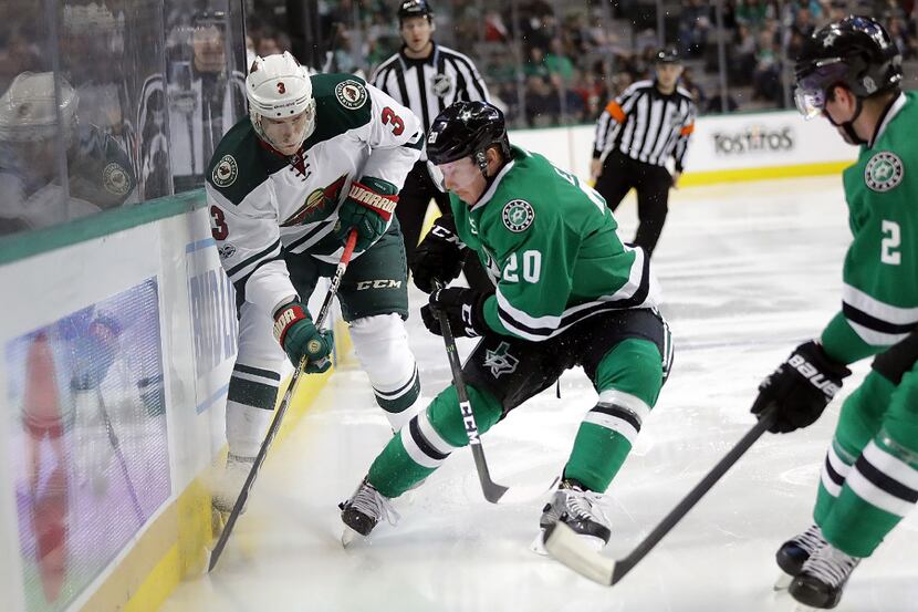 DALLAS, TX - JANUARY 24:  Charlie Coyle #3 of the Minnesota Wild skates the puck against...
