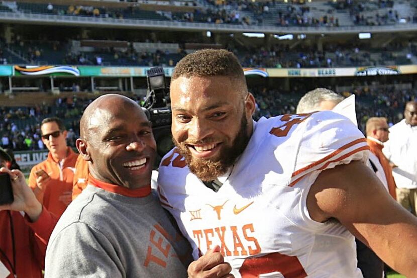 Texas Head Coach Charlie Strong, left, and Caleb Bluiett celebrate a 23-17 win over Baylor...