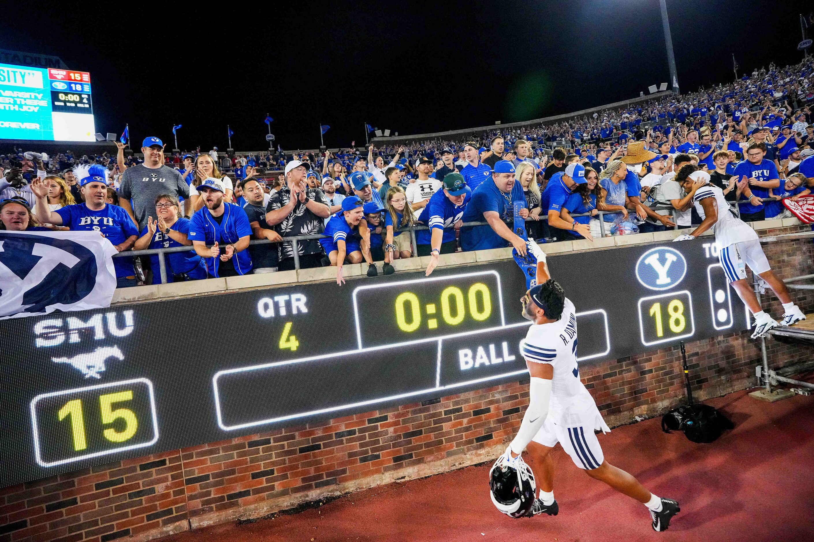 BYU safety Raider Damuni (3) celebrates with fans after an 18-15 victory over SMU in an NCAA...