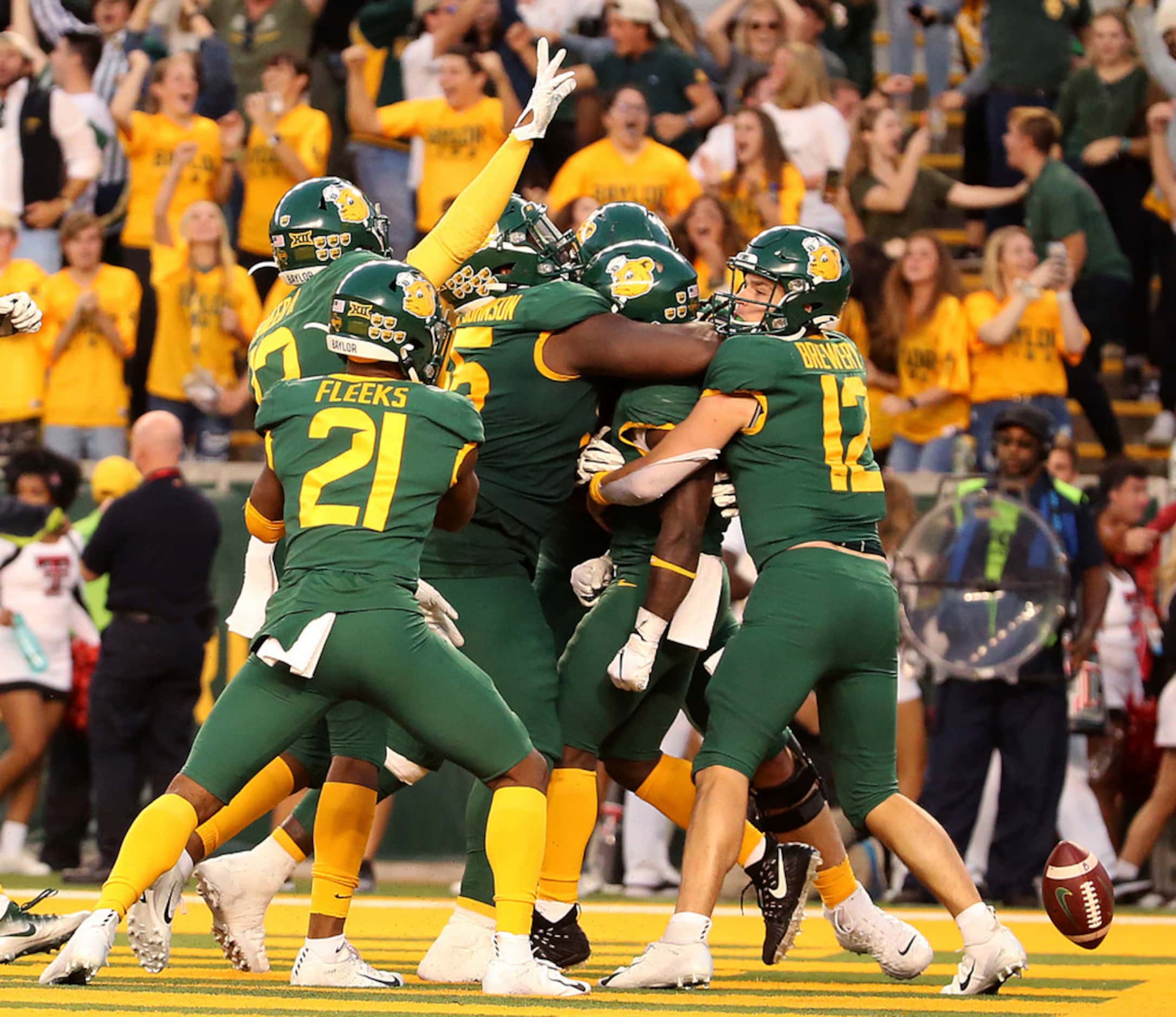 Baylor quarterback Charlie Brewer (12), right celebrates a touchdown with his teammates...