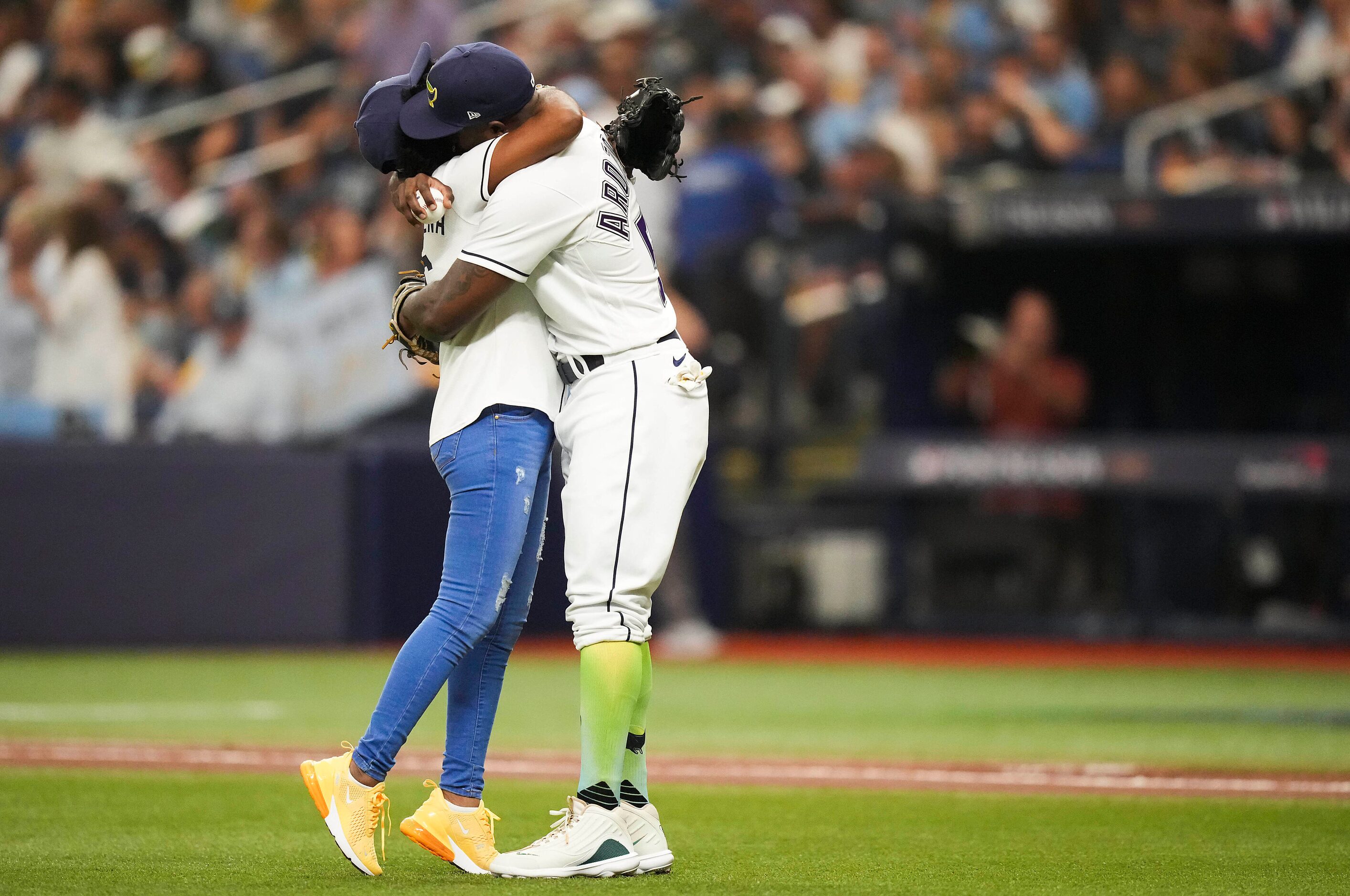 Tampa Bay Rays left fielder Randy Arozarena hugs his mother Sandra Gonzalez after she threw...