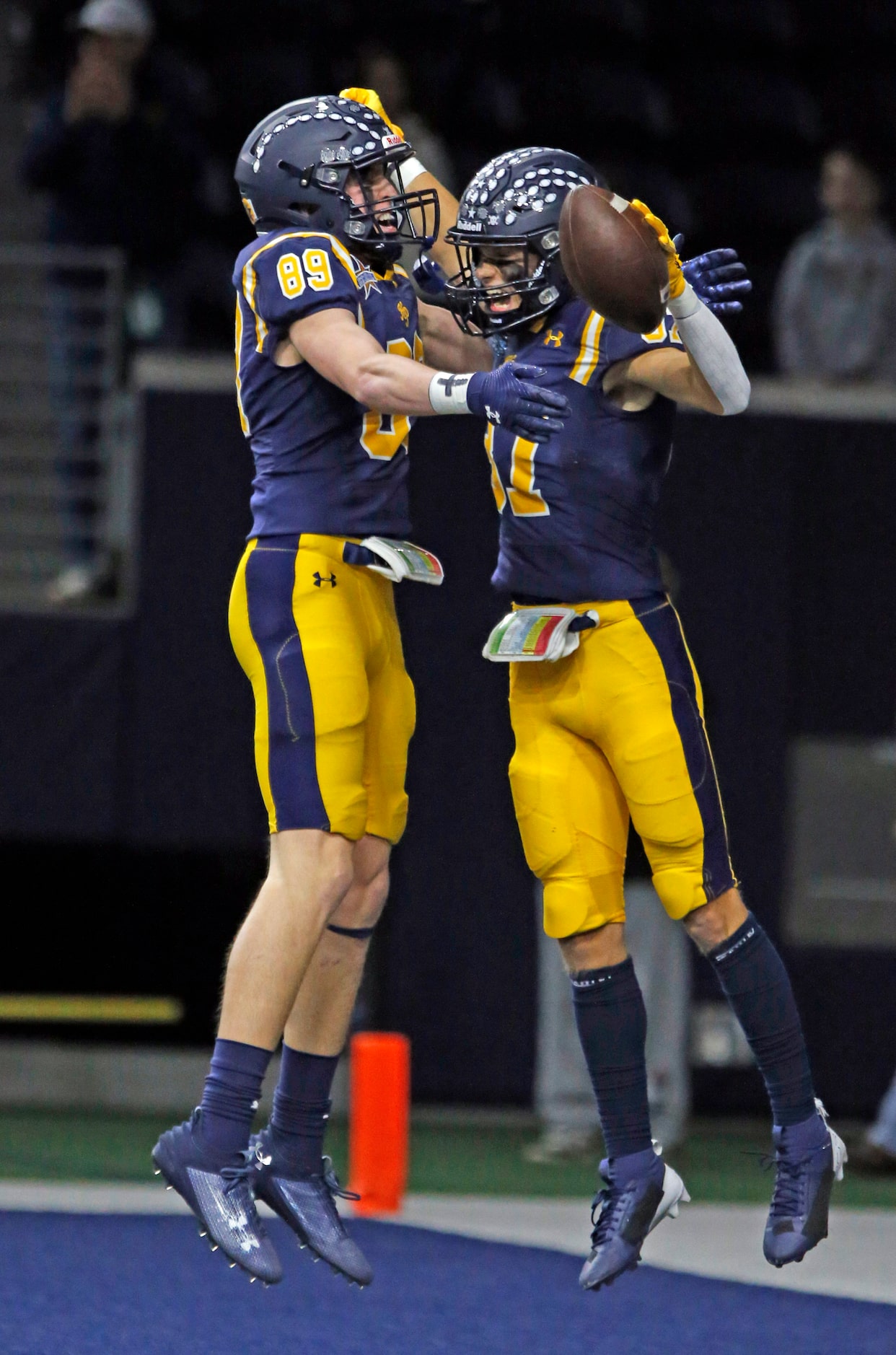 Highland Park High’s Case Messer (89) and Cannon Bozman (37) celebrate Bozman’s touchdown...