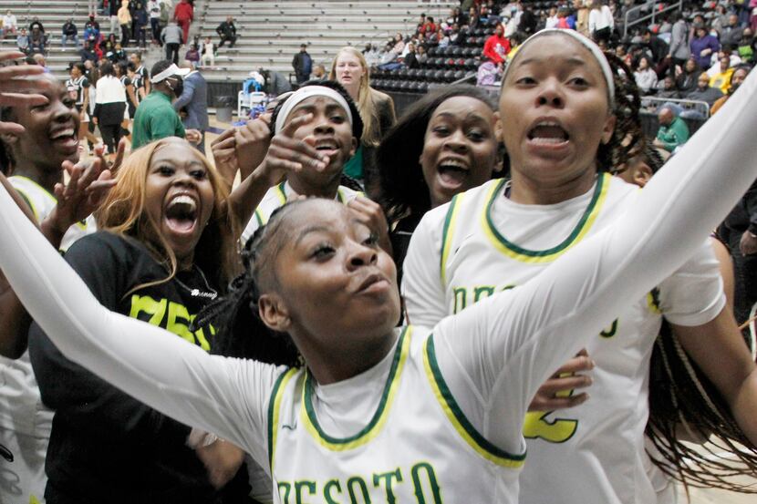 DeSoto guard Ja'Mia Harris (4) captures a video as she celebrates with teammates following...