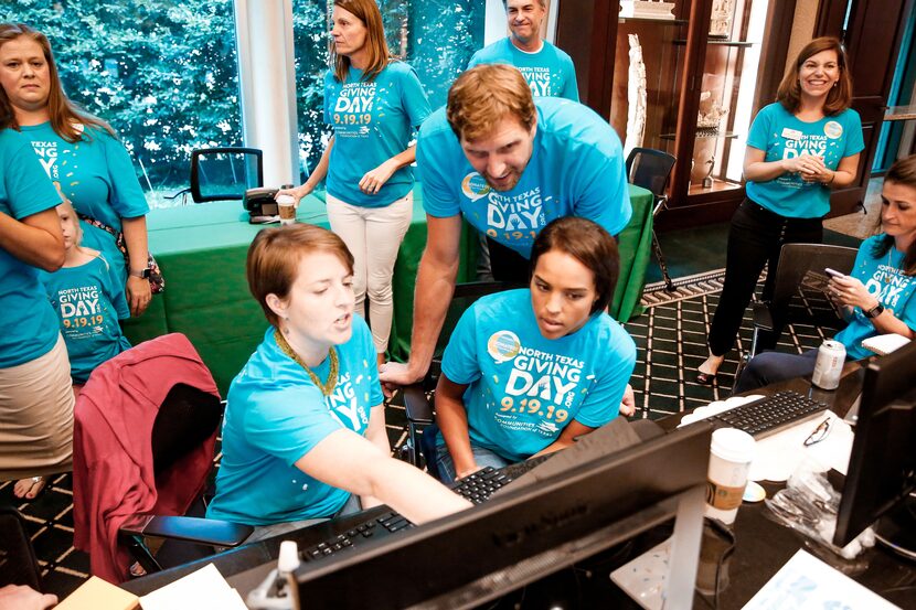 Dallas Mavericks legend Dirk Nowitzki and his wife, Jessica (seated at right), monitor...