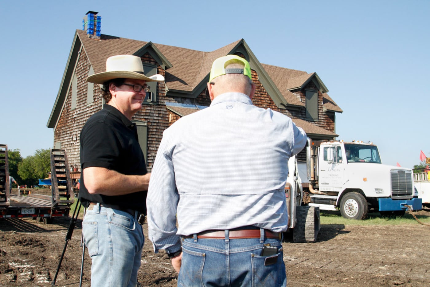 Clint Haggard talks with family friend Jeff Nesbitt in front of the Collinwood Home, built...
