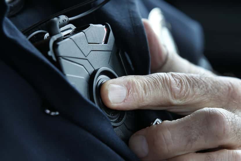  West Valley City patrol officer Gatrell starts a body camera recording by pressing a button...