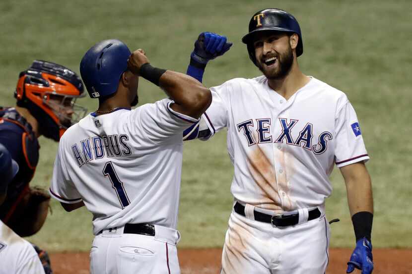 Texas Rangers' Joey Gallo, right, celebrates his two-run home run off Houston Astros...