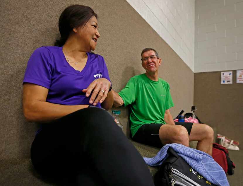 Tua Roose (left) and her husband Dan Roose talk during a break while they play pickleball at...