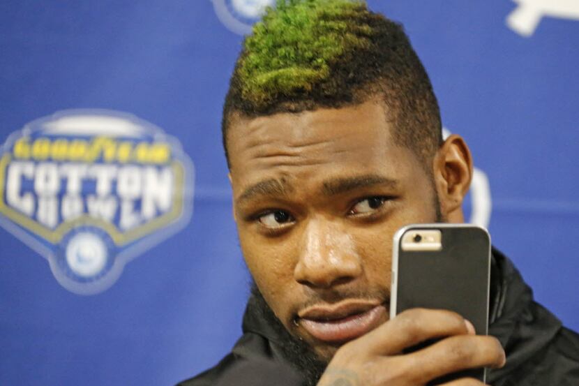 Baylor's Shawn Oakman takes a selfie during media day for the Goodyear Cotton Bowl at AT&T...