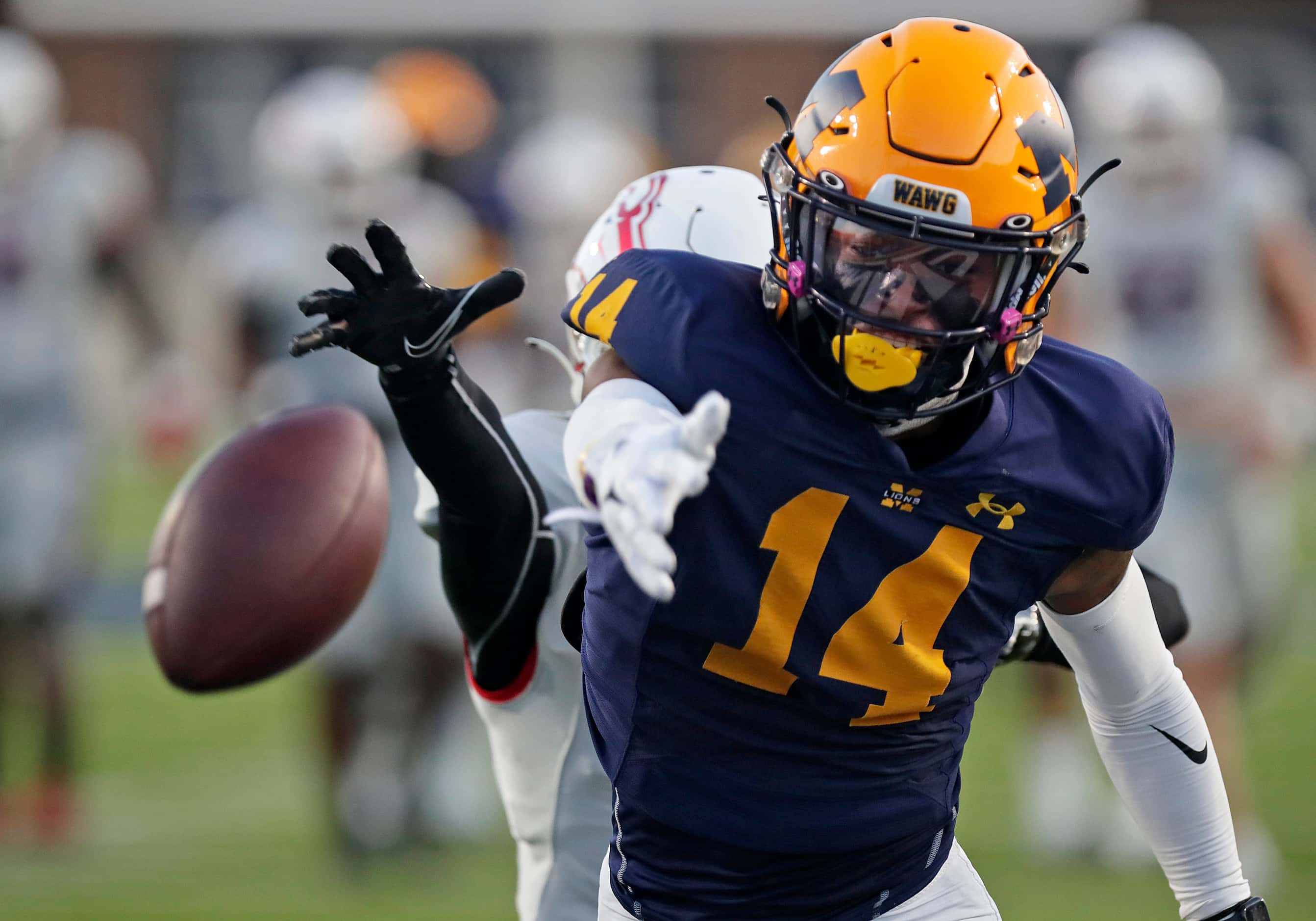The pass was just out of reach for McKinney High School wide receiver Khali Best (14) as...