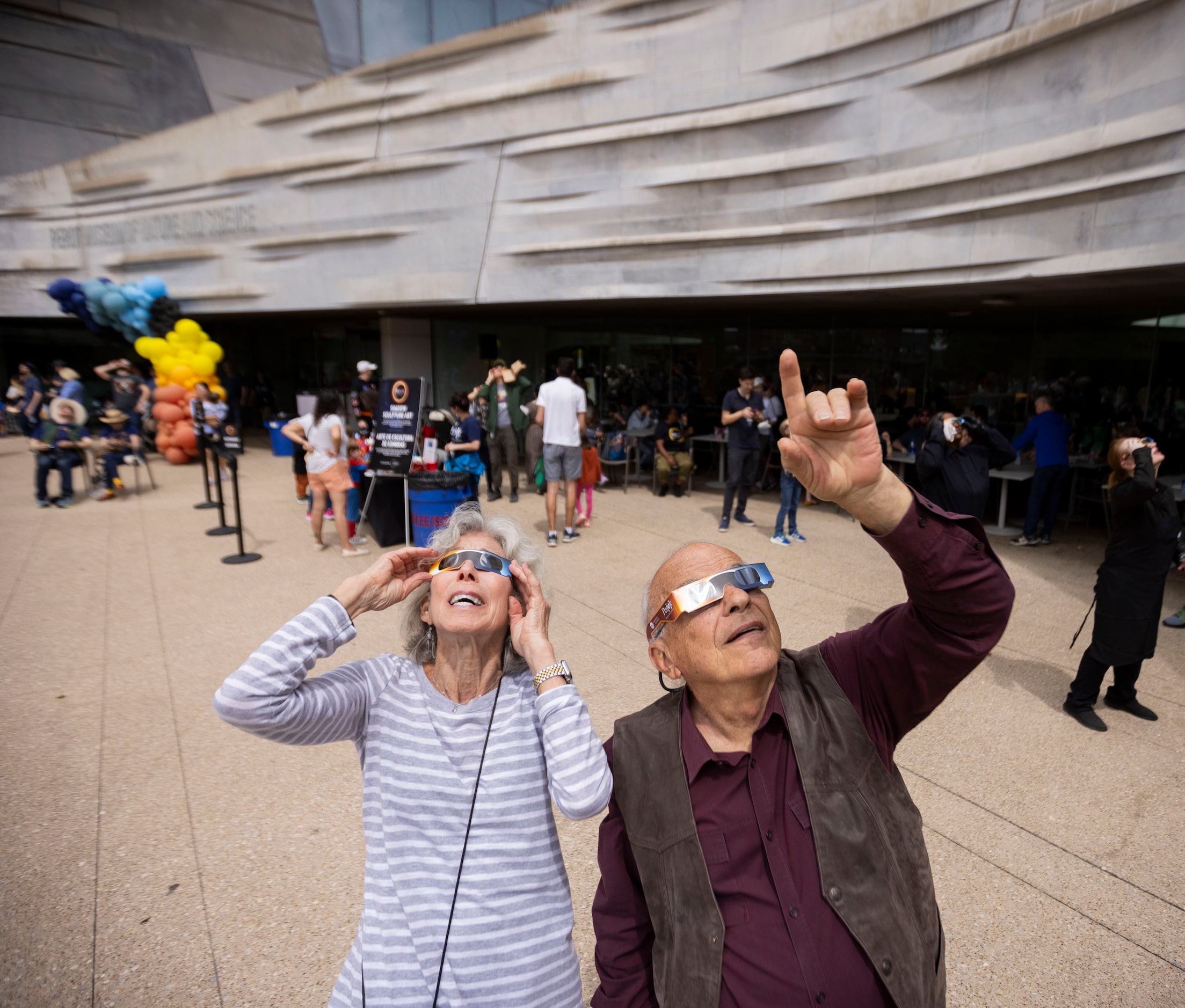 (From left) Liz Haberman and boyfriend Joe Semiraro look at the eclipse during the Great...