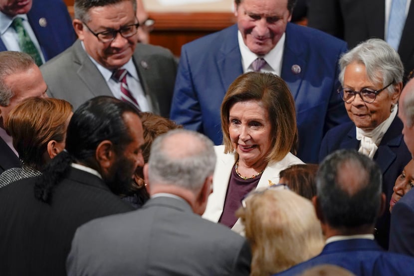 House Speaker Nancy Pelosi of Calif., is surrounded by lawmakers including Senate Majority...